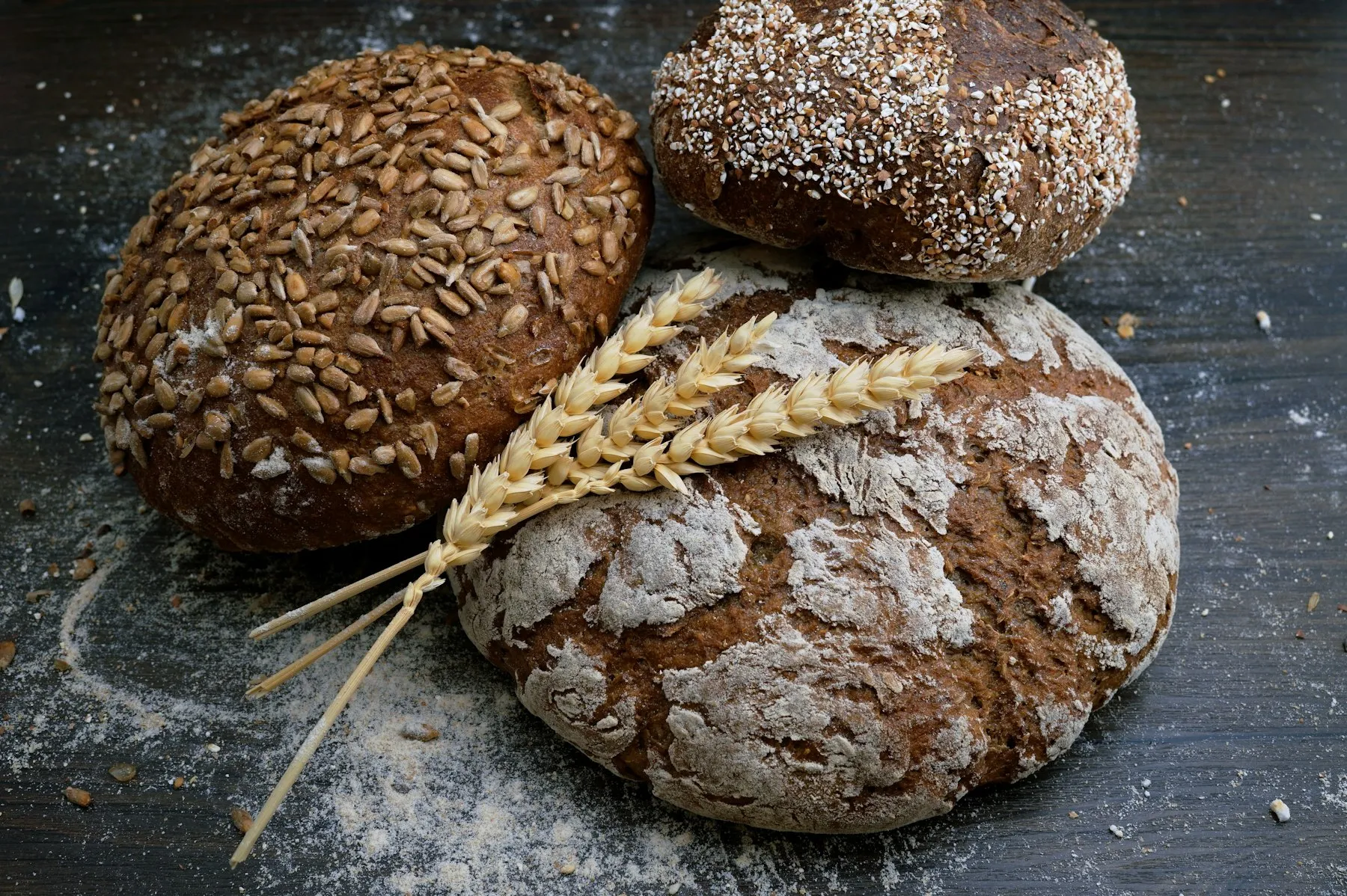 Three rustic sourdough loaves dusted with flour
